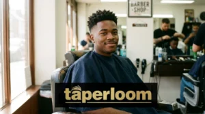 Man with low taper fade and short textured hair in barbershop