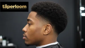 Low taper fade afro haircut on a Black man, clean fade with full natural afro on top