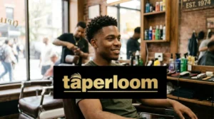 Black man with a fresh low taper fade haircut sitting in a barber chair