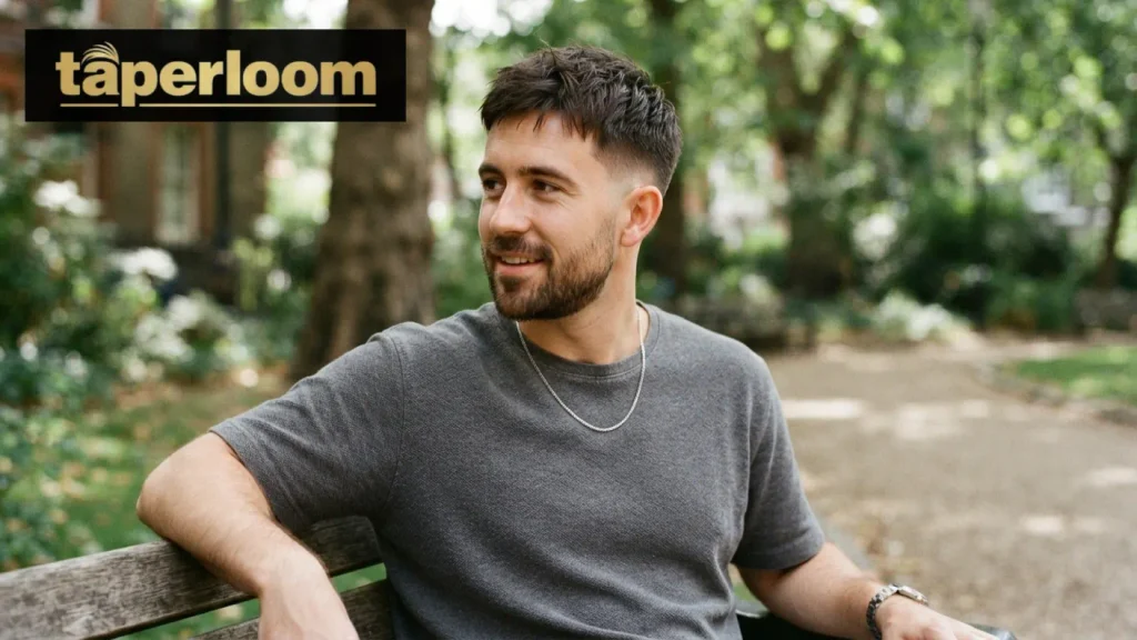Man with short straight hair styled with a low taper fade